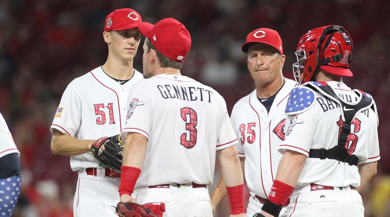 Reds manager Jim Riggleman visits the mound during a game against the White Sox on Tuesday, July 3, 2018, at Great American Ball Park in Cincinnati. David Jablonski/Staff
