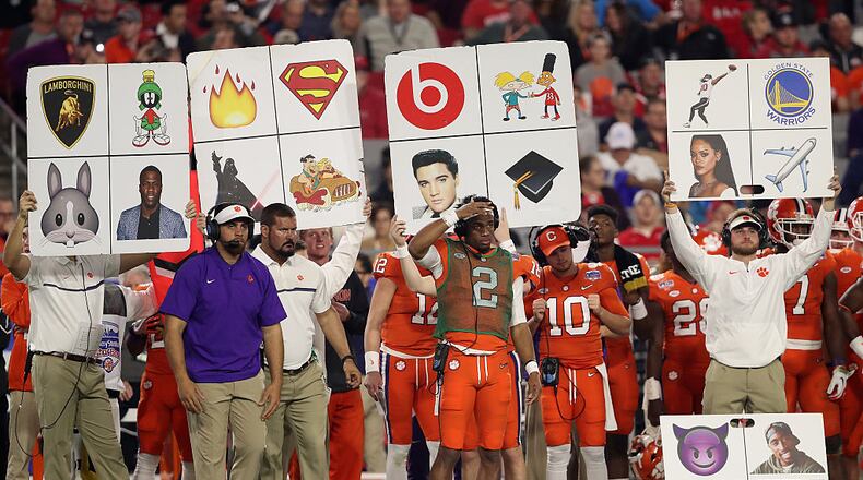 GLENDALE, AZ - DECEMBER 31: The Clemson Tigers sidelines holds up play cards during the Playstation Fiesta Bowl against the Ohio State Buckeyes at University of Phoenix Stadium on December 31, 2016 in Glendale, Arizona. The Tigers defeated the Buckeyes 31-0. (Photo by Christian Petersen/Getty Images)