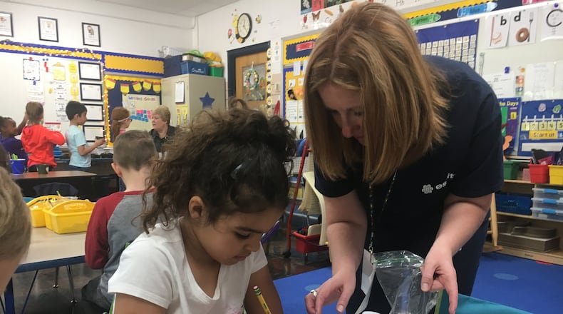 Kindergarten student Arilyn McNair plants a “tickle me” seed with assistance from her teacher, Emily Young, during an Earth Day project Monday at Monroe Primary School. The program was sponsored by Essity Paper in Middletown. RICK McCRAB/STAFF