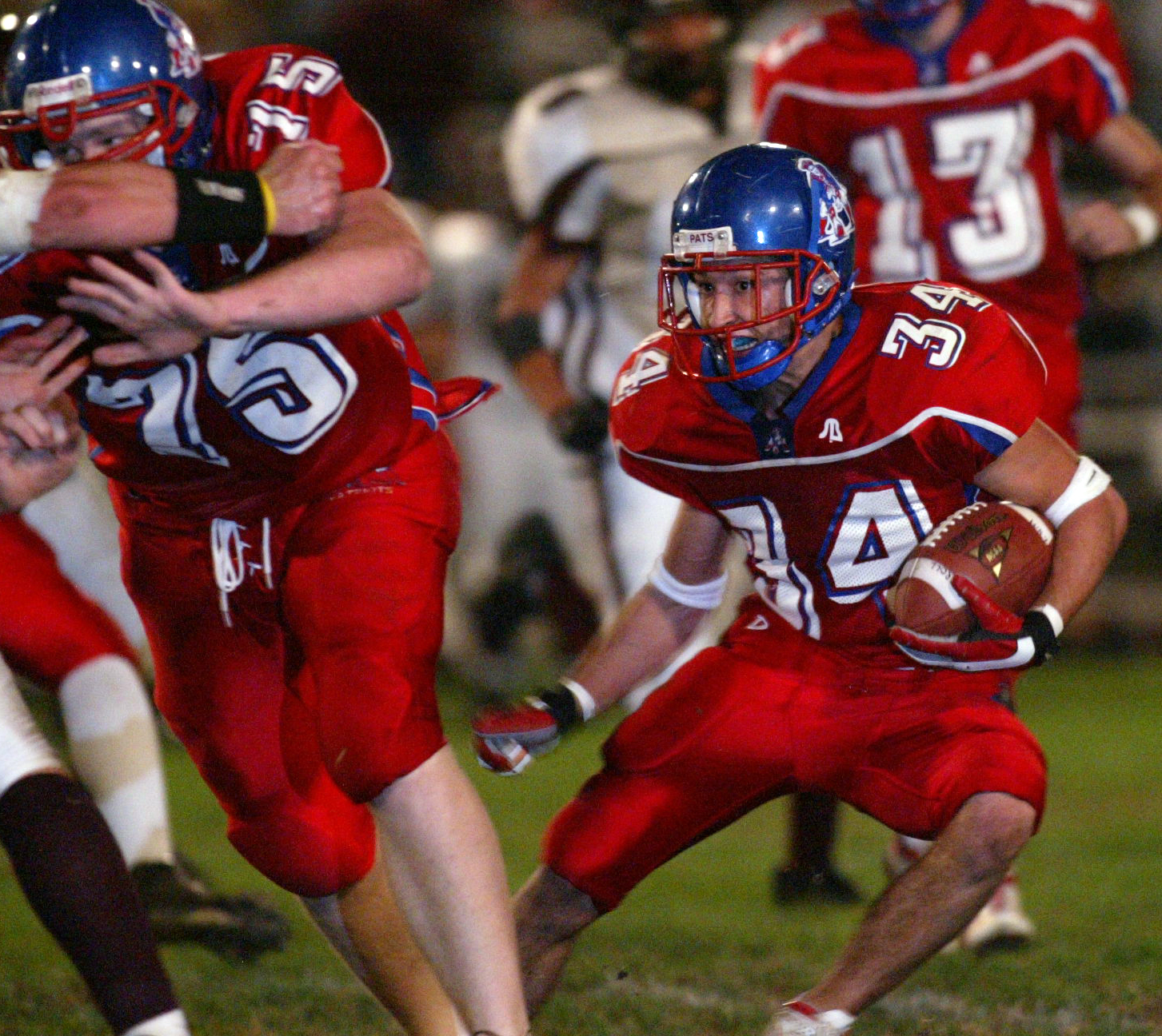 Lyle Garrison, of Carroll High School, runs behind the blocking of offensive lineman Erik Gohmann (75) during the game against Lebanon in 2004. RON ALVEY / STAFF