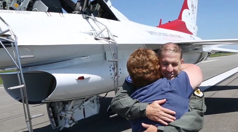Dayton Airport Fire Captain Brian Seidenschmidt hugs his wife Erin after his flight in a Thunderbird F-16 on Friday at the Dayton International Airport before the weekend Dayton Air Show. TY GREENLEES / STAFF