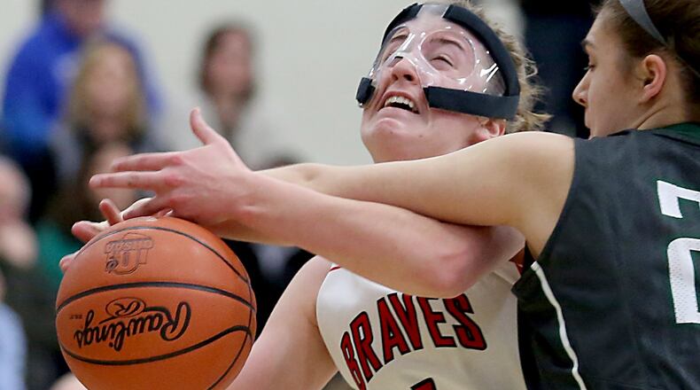 Talawanda guard Emma Wright is fouled by Ursuline forward Emma Cain during Wednesday night’s Division I sectional game at Lakota East. CONTRIBUTED PHOTO BY E.L. HUBBARD