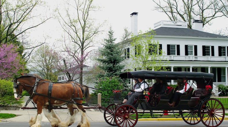 A Clydesdale-drawn carriage passes in front of Lewis Place, the home of Miami University’s presidents, during a previous Red Bricks and Roses event. CONTRIBUTED