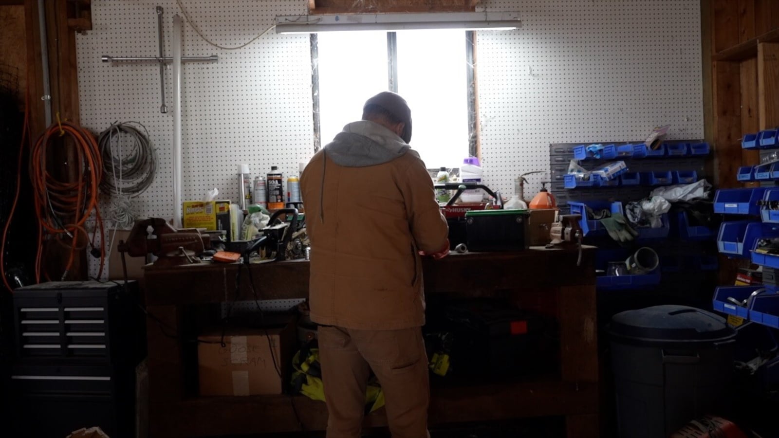 Farm Manager Nathan Reidel tries to fix a wood chipper at the farm at Aberlin Springs, a subdivision built around the working farm. KEITH BIERYGOLICK/WCPO