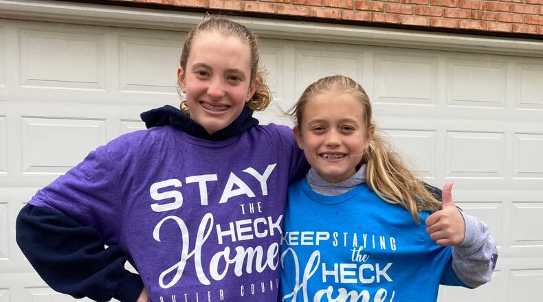 Kaylyn, 12, and Molly Macechko, 9, have spreading the message wearing their own pastel t-shirts with Butler County Health Commissioner Jennifer Bailer’s slogan “Stay the Heck Home, and creating positive messages via chalk art during their break from Tawlawada schools. SUBMITTED