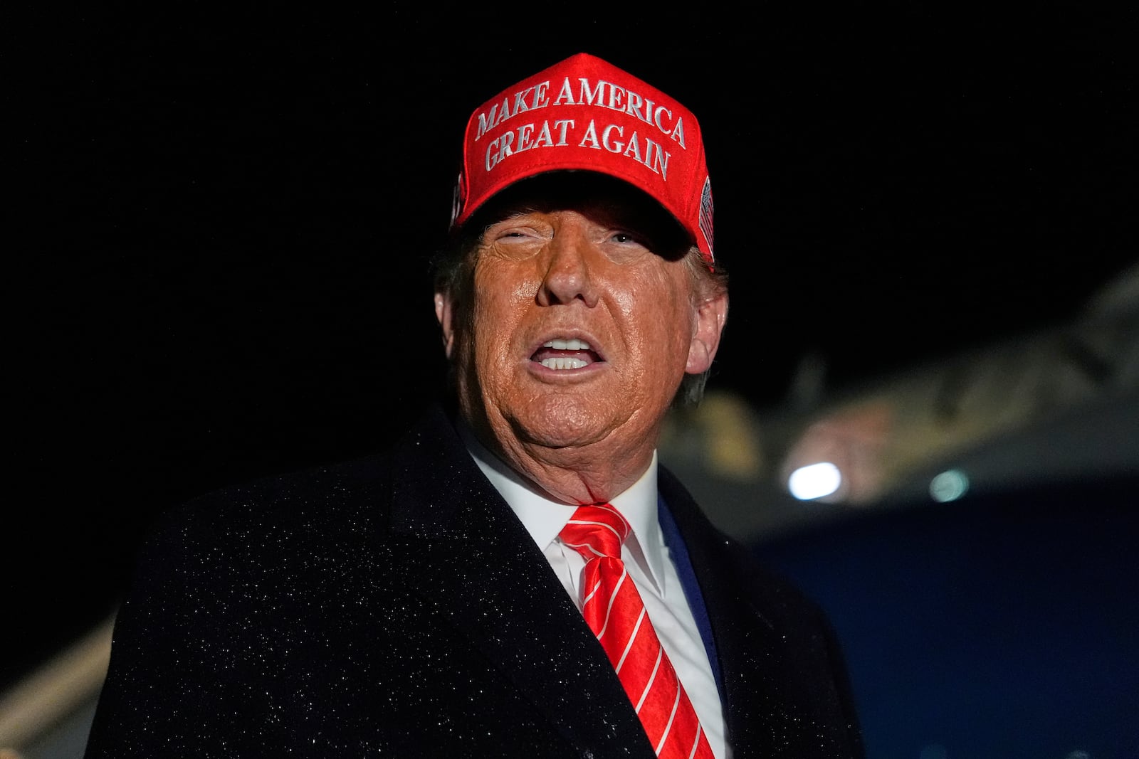 President Donald Trump speaks to reporters in the rain after arriving on Air Force One at Joint Base Andrews, Md., Friday, May 30, 2025. (AP Photo/Julia Demaree Nikhinson)
