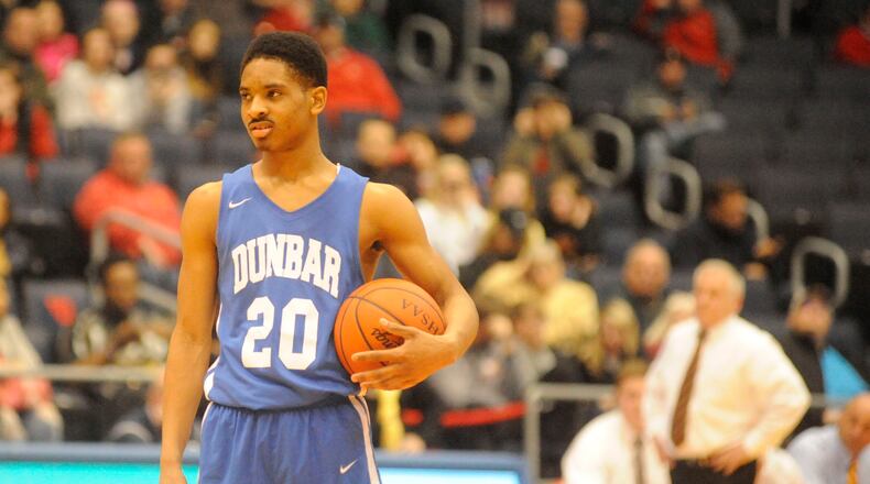 Dunbar’s Michael Elmore holds the ball during the Wolverines’ 27-26 win over Fenwick in a Division II sectional final March 7 at the University of Dayton Arena. MARC PENDLETON/STAFF