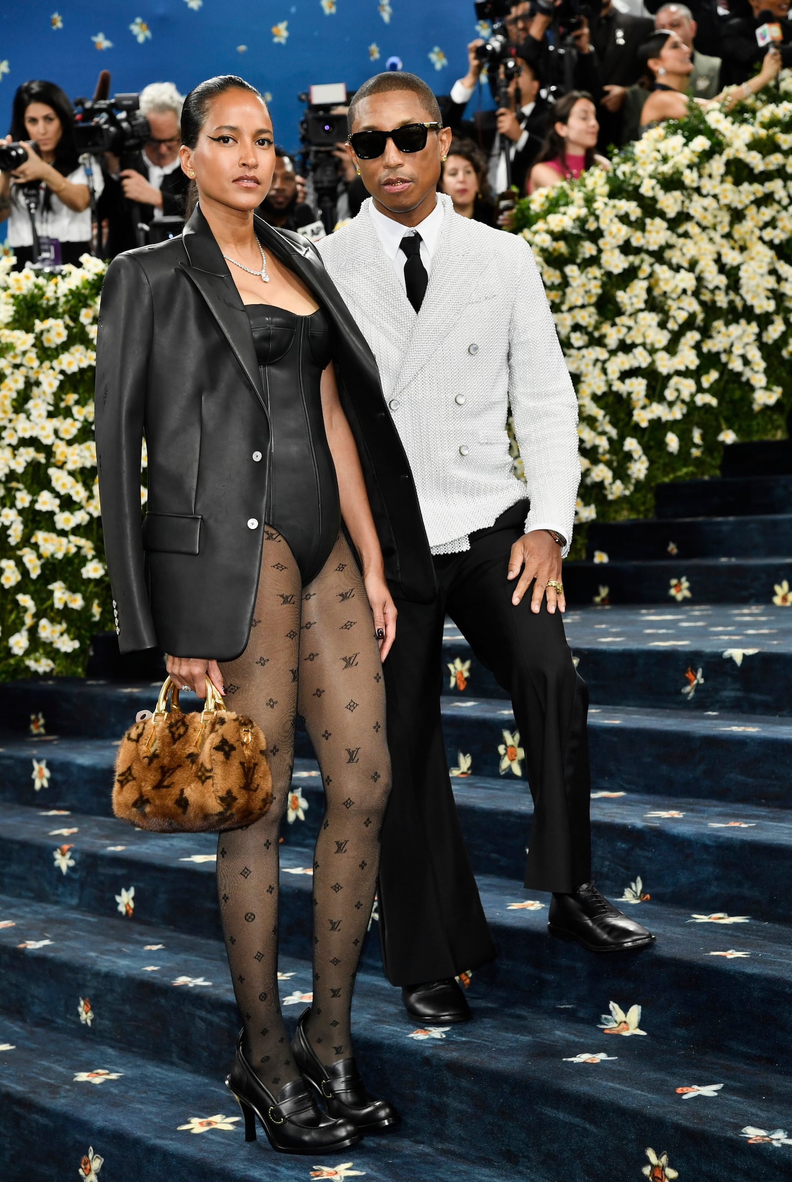 Helen Lasichanh, left, and Pharrell Williams attend The Metropolitan Museum of Art's Costume Institute benefit gala celebrating the opening of the "Superfine: Tailoring Black Style" exhibition on Monday, May 5, 2025, in New York. (Photo by Evan Agostini/Invision/AP)