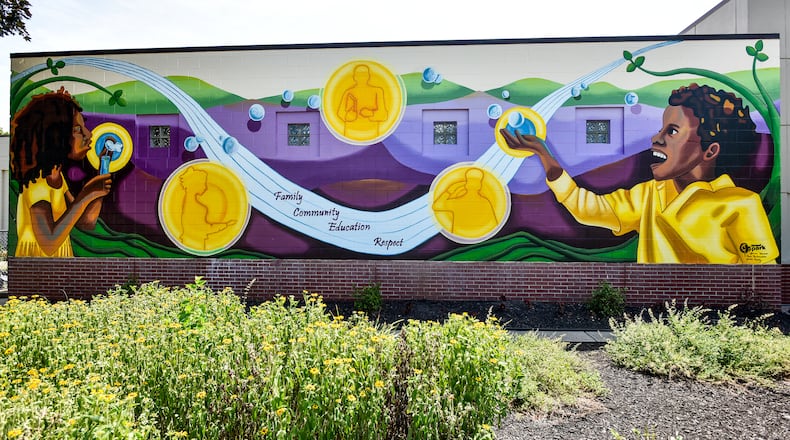 The 2019 StreetSpark mural titled " Inspiring the Future" is completed on the front of the Booker T. Washington Community Center on S. Front Street in Hamilton. The mural was designed by Jamie Schorsch. NICK GRAHAM/STAFF