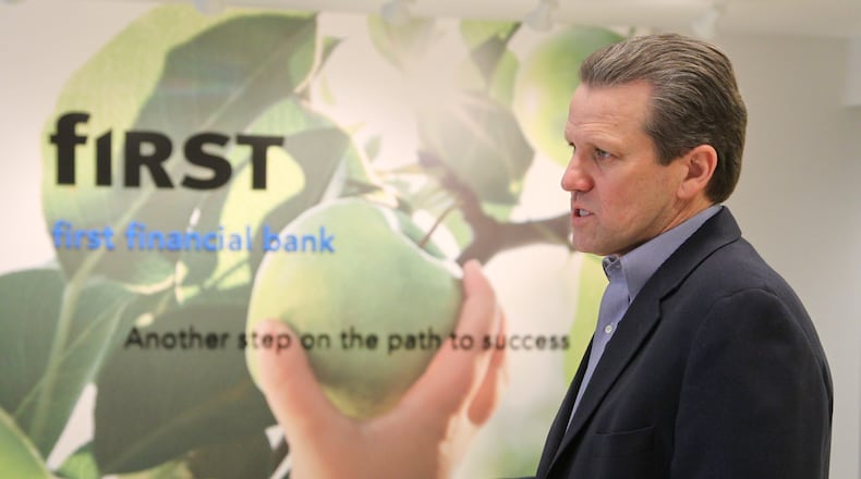 In this 2012 file photo, Claude Davis, president and chief executive officer, First Financial Bank, leads a tour of First Financial’s renovated training center space at the bank’s former High Street headquarters in Hamilton. First Financial plans to relocate from Stewart Square in Oxford to the city’s new Bishop Square mixed used development later this year. GREG LYNCH/STAFF