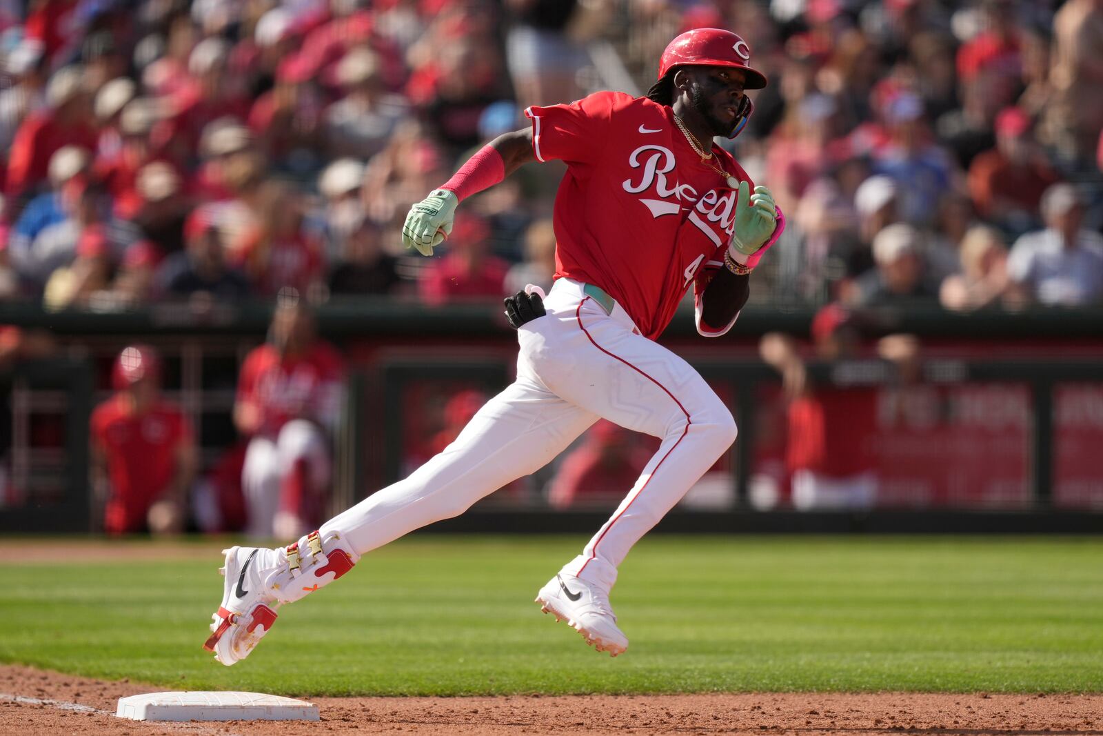 Cincinnati Reds' Elly De La Cruz rounds first base after hitting an RBI double scoring Matt McLain during the sixth inning of a spring training baseball game against the San Diego Padres, Saturday, March, 1, 2025, in Goodyear, Ariz. (AP Photo/Carolyn Kaster)