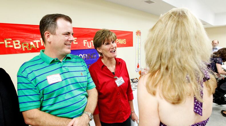 Mike Gigis (left), co-owner of the West Chester Veterinary Center, socializes with PAWS board of directors president Sue Hutson (center) and Juli Nimitz, director of the PAWS capital campaign, during a VIP event held Thursday, Aug. 7, at their new facility on Crossings Blvd. in Monroe.