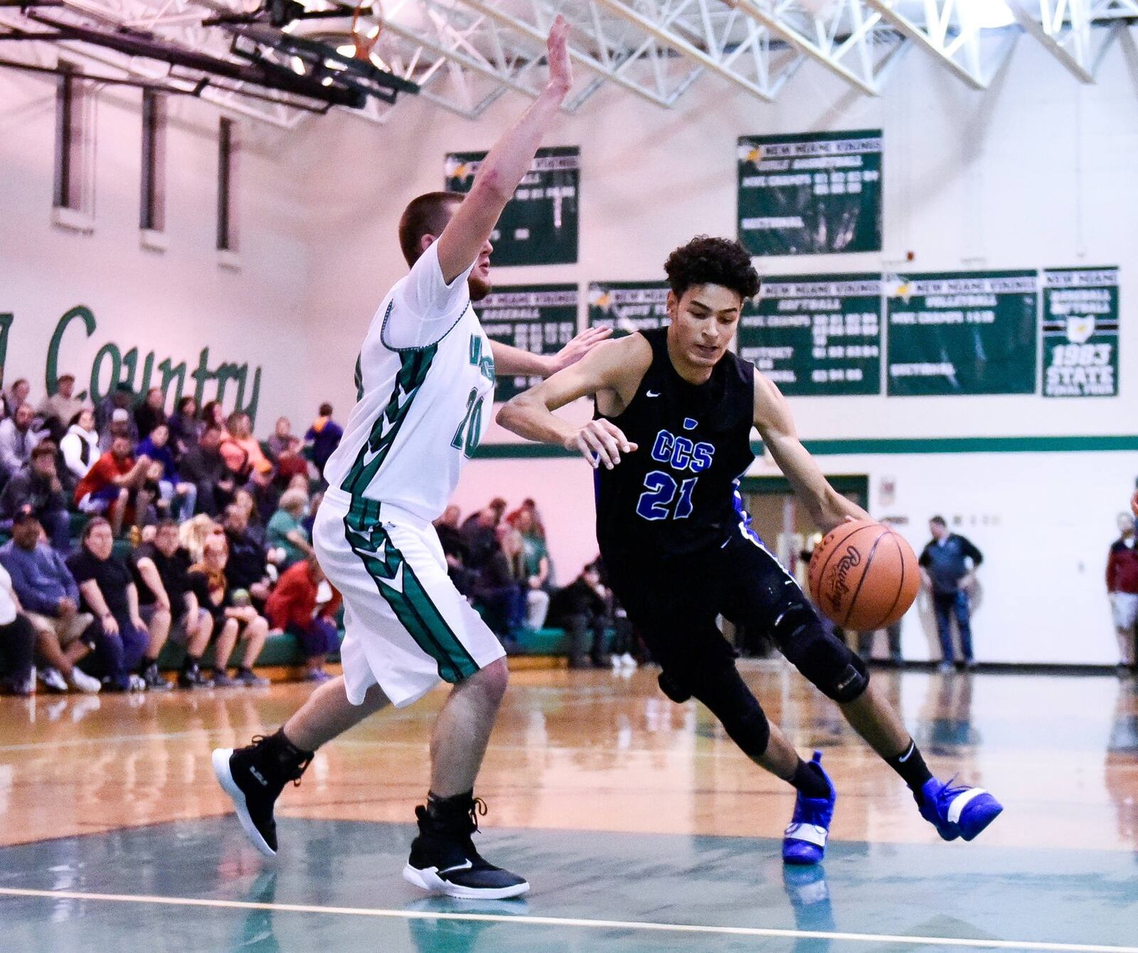 Cincinnati Christian’s Jalon Percy dribbles to the hoop defended by New Miami’s Ronnie Bowman during Friday night’s game at New Miami. Cincinnati Christian won 70-52. NICK GRAHAM/STAFF