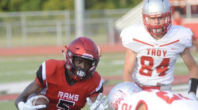 Trotwood’s William McDaniel (with ball) is pursued by Troy’s Kobe Feltner (22) and Spencer Klopfenstein. Trotwood-Madison defeated Troy 48-0 in a Week 1 high school football game on Friday, Aug. 25, 2017. MARC PENDLETON / STAFF