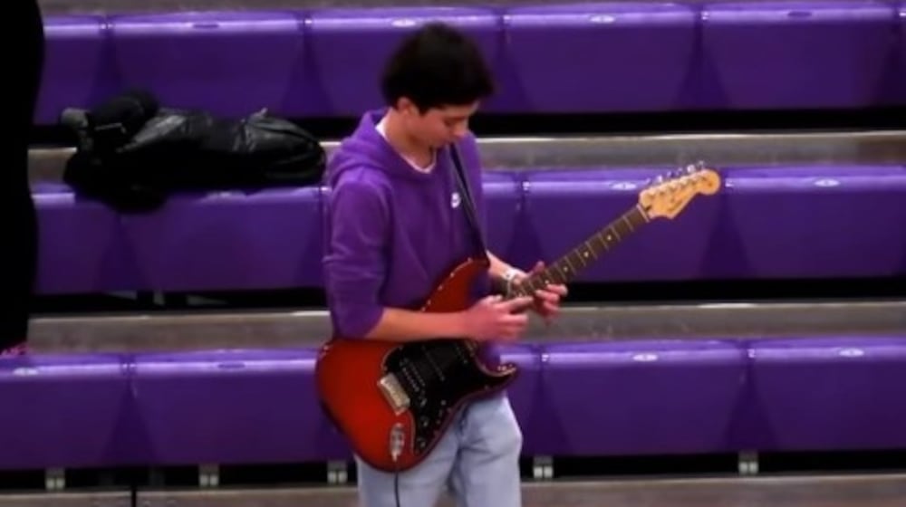 Middletown High School student Dylan Palmer plays guitar at a recent basketball game in the Middies' gymnasium. CONTRIBUTED