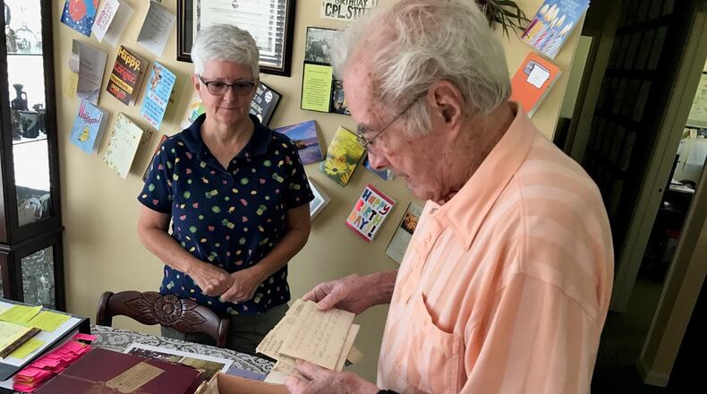 With daughter Beverly Rutan looking on, Walter Stitt looks at one of the 82 letters (the rest are in the hat box in front of him) he wrote during World War II to his mother who was living in West Virginia. Some of his letters were penned when he was in basic and advanced training at Camp Polk, Louisiana and the rest came as he served in Sherman tanks in France, Belgium and Germany. He was in some of the war’s deadliest battles: the Battle of Normandy and the Battle of the Bulge. Twice his tank commanders and others alongside him in tanks were killed by German shells. He received two Purple Hearts; the National Order of the Legion of Merit, the highest honor of France; and the Order of Saint George Medallion, the top award given to members of the Army's mounted force (tanks, cavalry) by the United States Armor Association of the United States Army. Tom Archdeacon/CONTRIBUTED