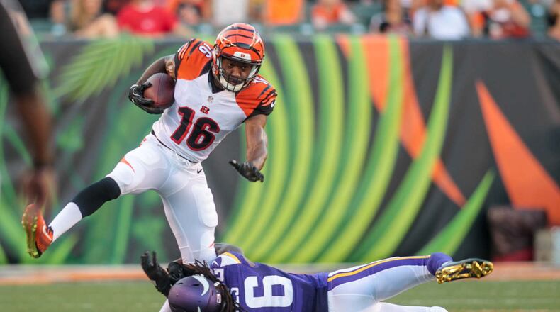 Cincinnati Bengals wide receiver Cody Core tries to avoid a tackle by Minnesota Vikings cornerback Trae Waynes during the first quarter of their first pre-season game Friday, Aug. 12 at Paul Brown Stadium in Cincinnati. NICK GRAHAM/STAFF