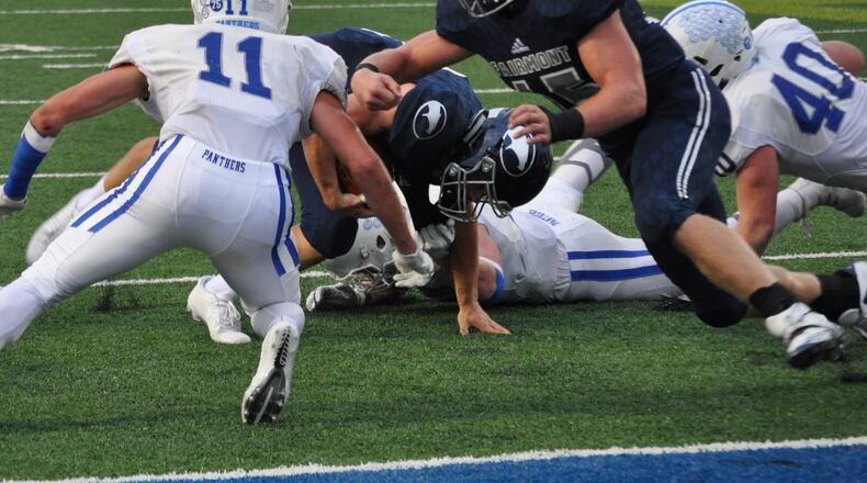 Fairmont junior Jesse Deglow throws a block as teammate Braden Miller tries to regain his balance near the end zone during the Firebirds’ 40-38 victory over visiting Springboro on Sept. 15 at Roush Stadium in Kettering. That’s the Panthers’ Josh Collins (11) and Lincoln Troxell (40) in on the play. CONTRIBUTED PHOTO BY NICK DUDUKOVICH