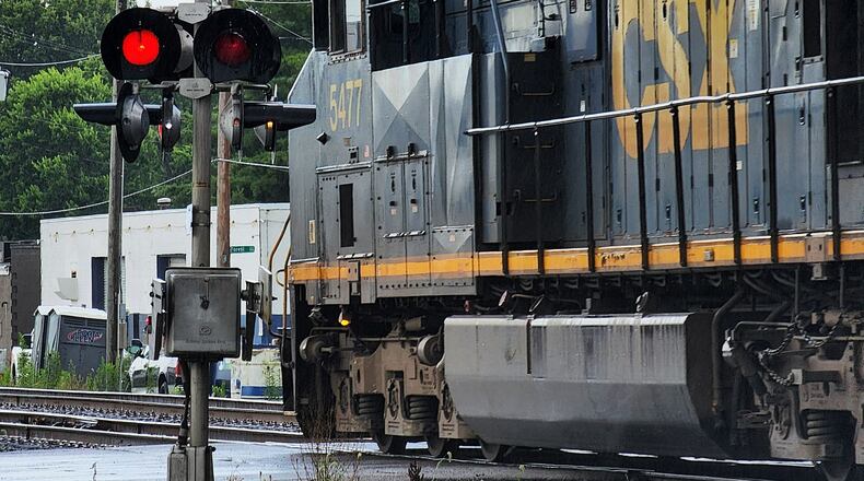 A CSX train travels along the railroad tracks crossing Laurel Avenue last year in Hamilton. City officials had a meeting last week with CSX officials who said they would work with city leaders the best they could, but there is not much they can do about blocking railroad crossings. They did recommend motorists to call a toll-free number that's posted at every crossing if there are problems, including stopped trains. FILE