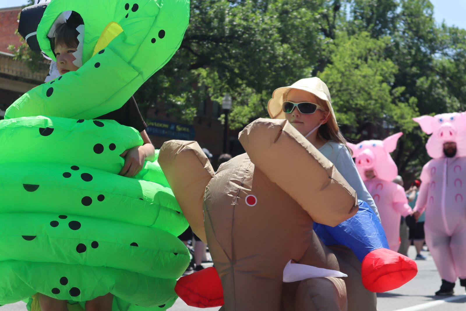 Children in inflatable costumes participate in the 'Rhino Rumble Road Race' to celebrate the 30th anniversary of the film 'Jumanji' in downtown Keene, N.H. on Saturday, June 21, 2025. (AP Photo/Leah Willingham)