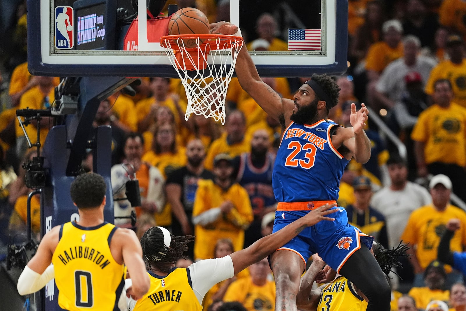 New York Knicks center Mitchell Robinson (23) dunks during the first half of Game 6 of the Eastern Conference finals of the NBA basketball playoffs against the Indiana Pacers in Indianapolis, Saturday, May 31, 2025. (AP Photo/Michael Conroy)