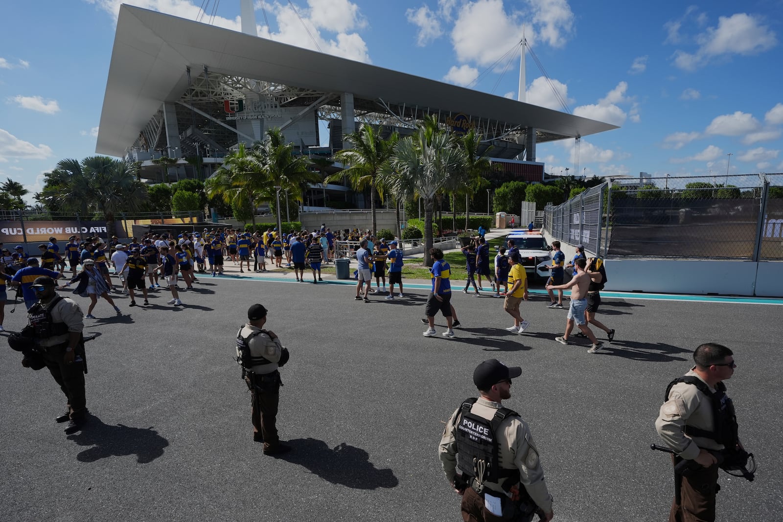 Law enforcement personnel stand outside the stadium prior to the Club World Cup group C soccer match between Boca Juniors and Benfica in Miami Gardens, Fla., Monday, June 16, 2025. (AP Photo/Rebecca Blackwell)