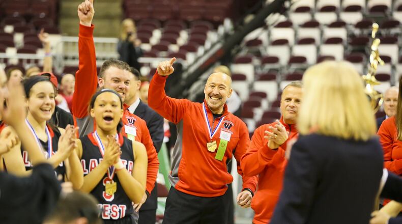Lakota West coach Andy Fishman (center) celebrates with his team March 21, 2015, after the Firebirds beat Toledo Notre Dame Academy 44-38 to win the Division I state championship at the Schottenstein Center in Columbus. GREG LYNCH/STAFF
