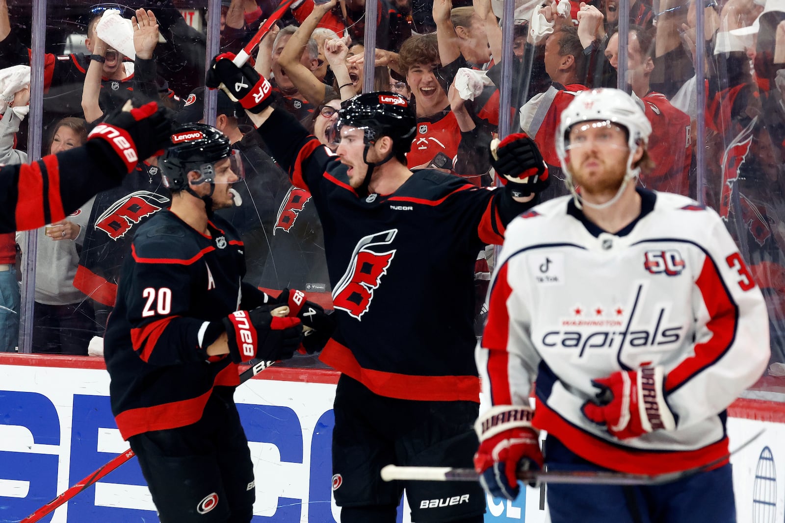 Carolina Hurricanes' Andrei Svechnikov, center, celebrates his goal with Sebastian Aho (20) during the second period of Game 3 of an NHL hockey Semi-final round playoff series against the Washington Capitals in Raleigh, N.C., Saturday, May 10, 2025. (AP Photo/Karl DeBlaker)