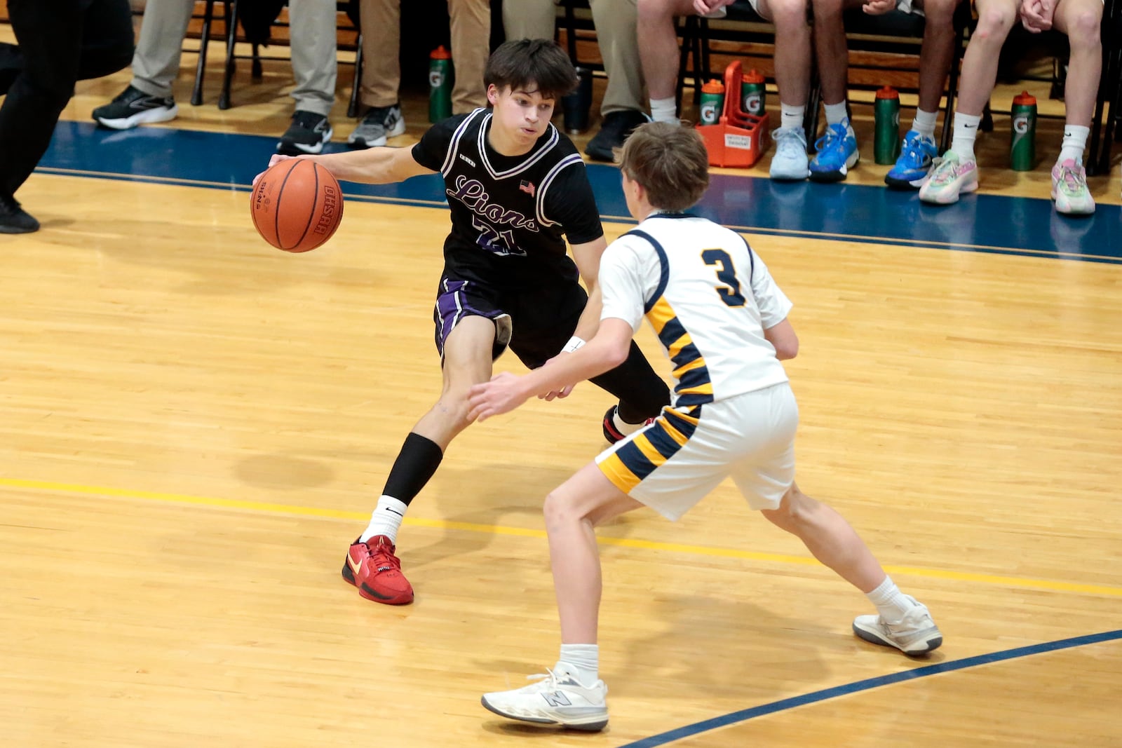 Emmanuel Christian junior Josh Witherow goes for a crossover dribble while guarded by Legacy Christian freshman Colin Graves. Emmanuel Christian defeated Legacy Christian 56-44 to clinch the Metro Buckeye Conference championship on Friday, Feb. 6, 2026, in Xenia. STEVEN WRIGHT / STAFF