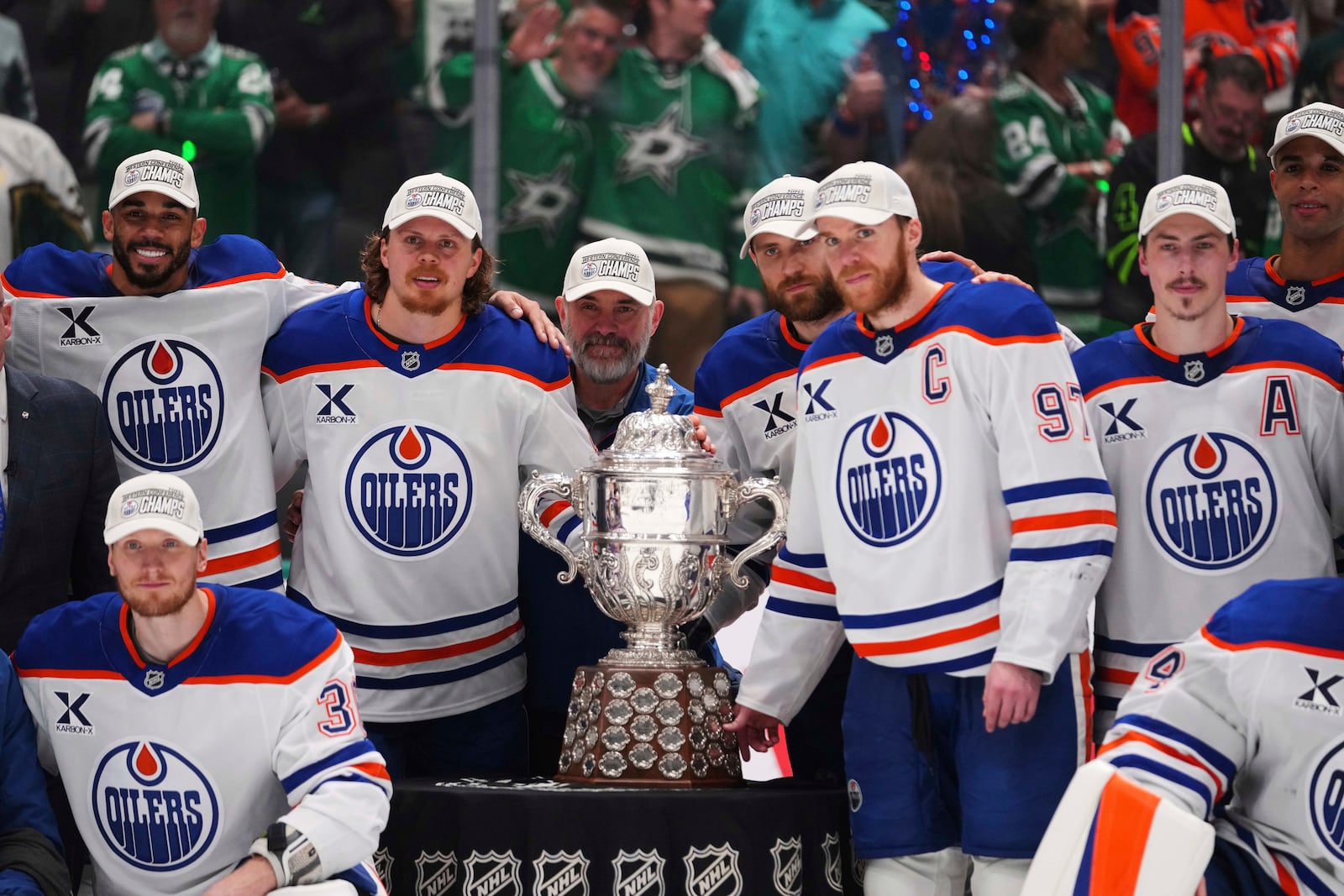 Edmonton Oilers pose for photos after winning Game 5 of the Western Conference finals against the Dallas Stars in the NHL hockey Stanley Cup playoffs, Thursday, May 29, 2025, in Dallas. (AP Photo/Julio Cortez)