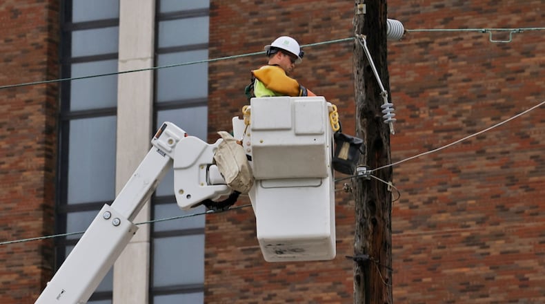 Hamilton city crews work to restore power on Dayton Street after storms with heavy rain and strong winds caused power outages and down trees and limbs around Butler County Monday evening, June 13, 2022. NICK GRAHAM/STAFF