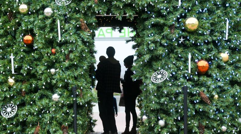 Shoppers walk through the Christmas Tree at Liberty Center as they shop on Black Friday, Nov. 25, 2016. GREG LYNCH / STAFF