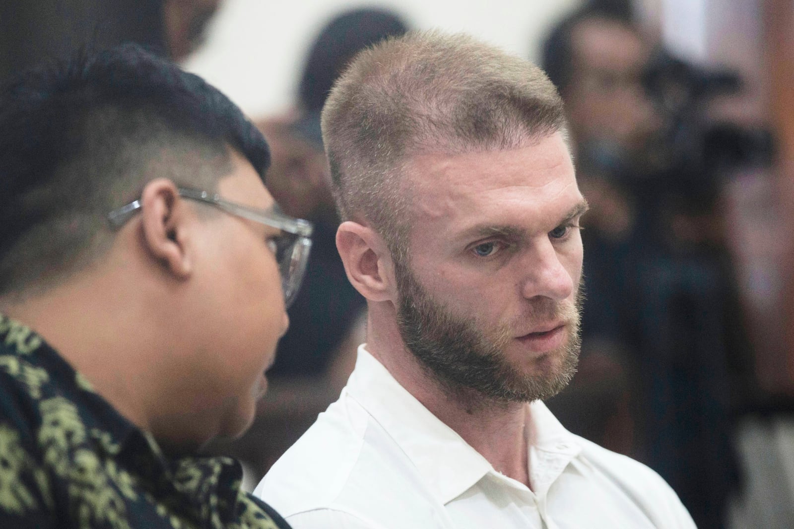 British citizen Thomas Parker who is accused of drug offenses listens to his interpreter during his trial hearing at a district court in Denpasar, Bali, Indonesia, Tuesday, May 20, 2025. (AP Photo/Firdia Lisnawati)