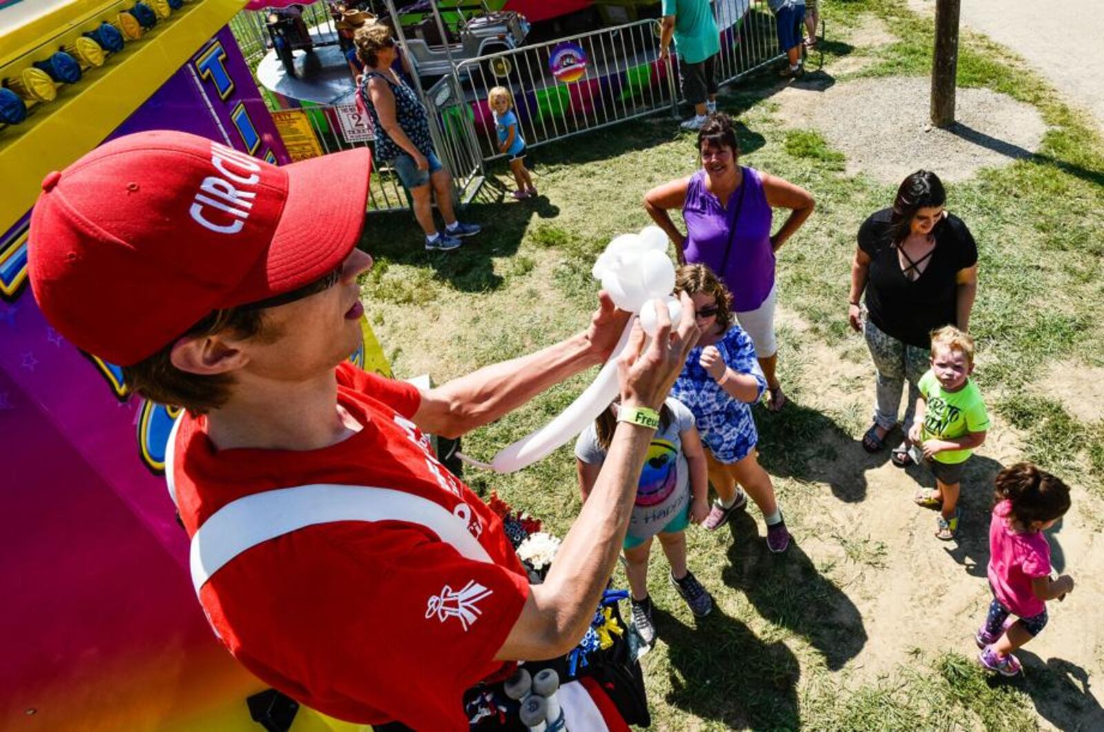 Spencer Ream with Cincinnati circus makes balloon animals for kids Wednesday, July 25 at the Butler County Fair in Hamilton. 