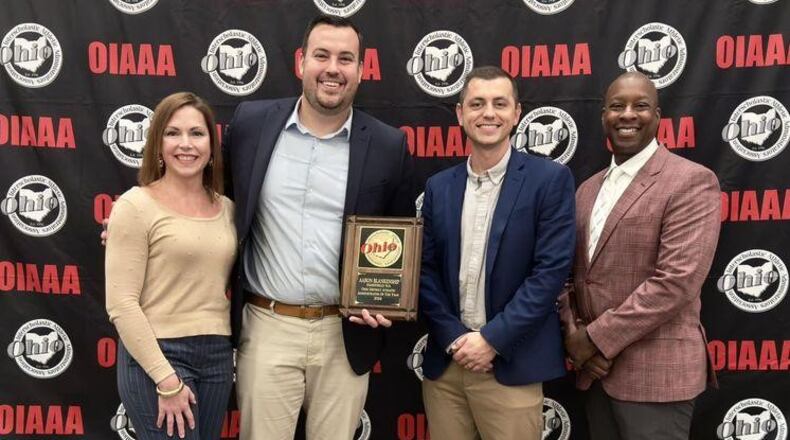 Fairfield Schools Athletic Director Aaron Blankenship was honored as the best at his job of overseeing all sports in the district by the Ohio Interscholastic Athletic Administrators Association (OIAAA) in a recent ceremony. Pictured L-R are Lori Payne, athletic department secretary; Blankenship; Kyle Smith, assistant athletic director and Carl Woods, athletic facilities coordinator for Fairfield Schools. (Provided)
