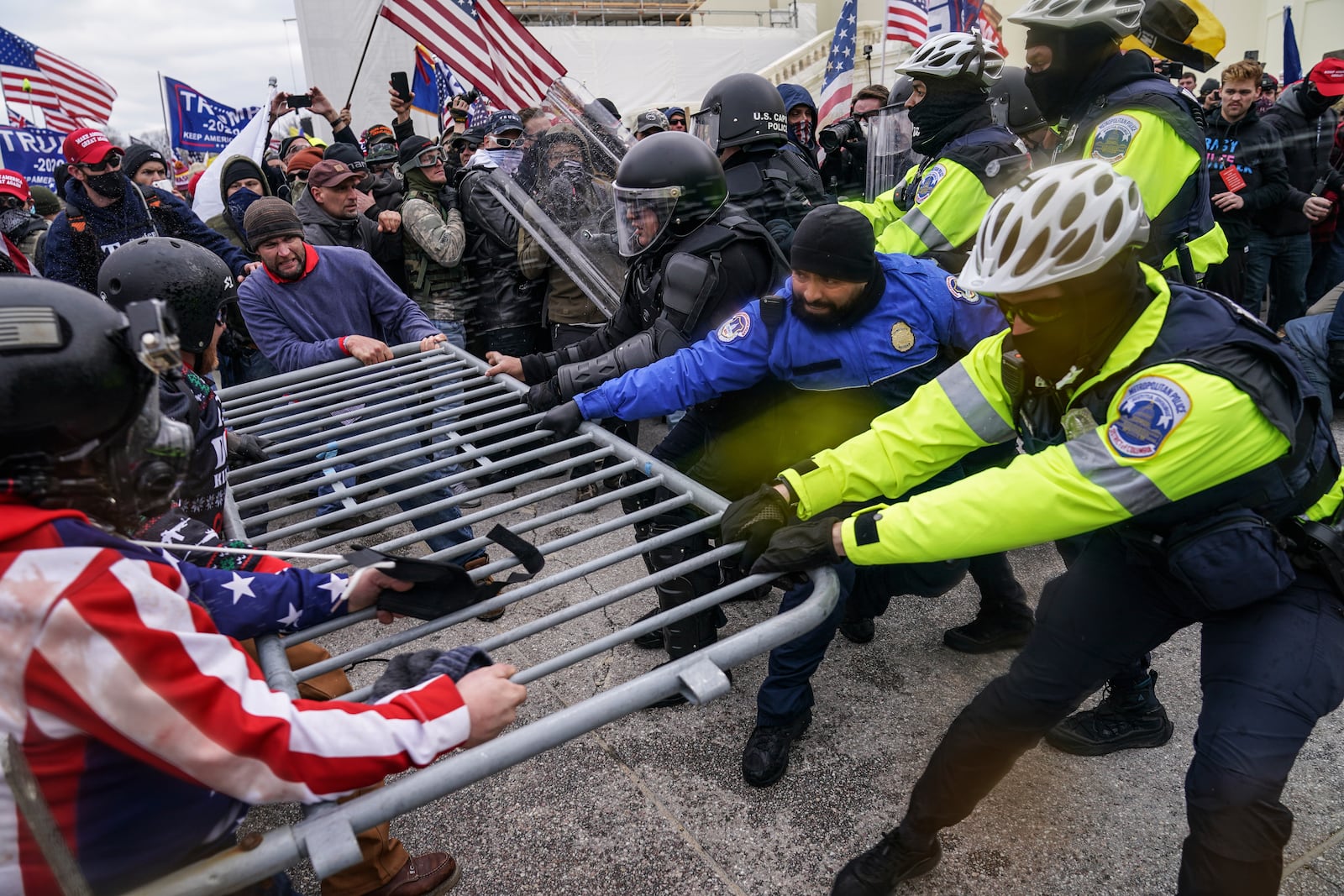 FILE - Supporters of President Donald Trump try to break through a police barrier, Jan. 6, 2021, during a riot at the Capitol in Washington. (AP Photo/John Minchillo, File)