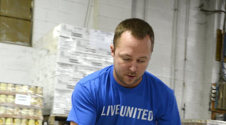 Shared Harvest Foodbank in Fairfield has seen its number of donors drop every year since 2011. For every $1 donated, it can provide seven meals. Pictured is Nathan Hoskins, the warehouse manager at Shared Harvest, loading up a pallet of canned food.