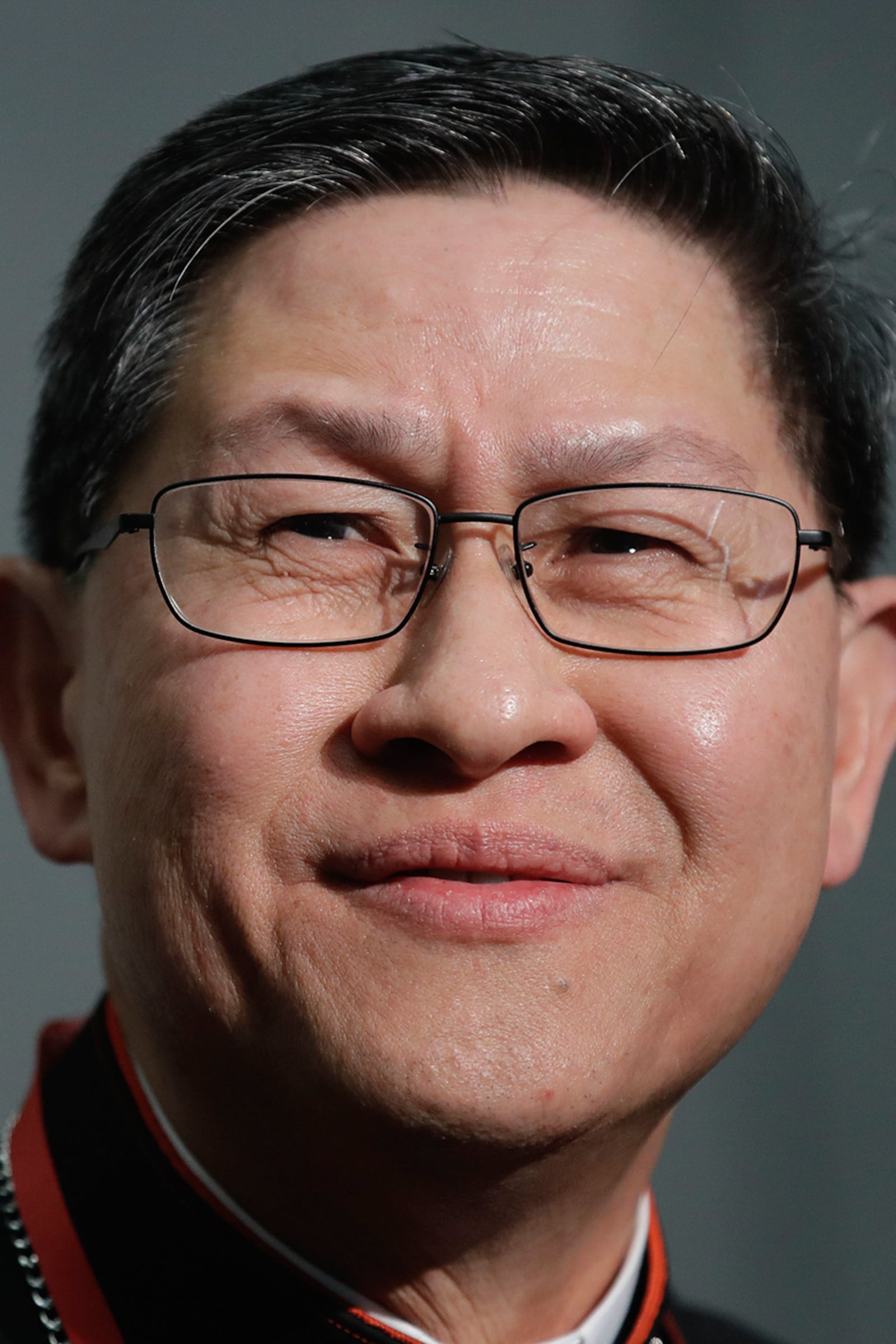 FILE - Cardinal Luis Antonio Tagle smiles during a news conference at the Vatican on Oct. 23, 2018. (AP Photo/Alessandra Tarantino, File)