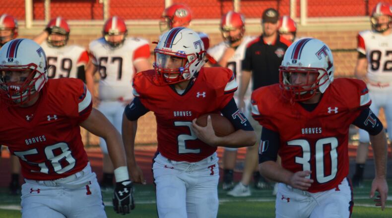 Talawanda sophomore quarterback Adam Crank (2) is flanked by teammates Tim Roberts (left) and Emmett Williams during a game against visiting New Richmond on Sept. 15, 2017. CONTRIBUTED/BOB RATTERMAN