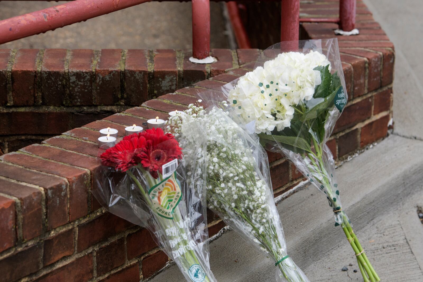 Flowers and candles are pictured as law enforcement work the scene after two staff members of the Israeli Embassy in Washington were shot and killed outside the Capital Jewish Museum, Thursday, May 22, 2025, in Washington. (AP Photo/Rod Lamkey, Jr.)