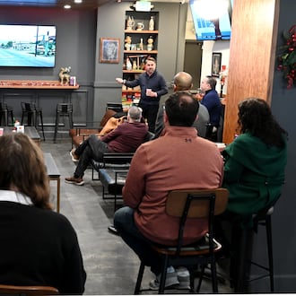 Butler County Finance Authority President and CEO Joshua Smith talks about the revitalization efforts in Hamilton during his tenure as city manager. Middletown leaders are considering a project that would demolish the Manchester Inn and construct a new mixed-use development that would include 100 to 125 apartments and 10,000 to 15,000 square feet of retail space. The meeting was held on Dec. 8, 2025, at the Pour House, which is at the Marcum in Hamilton, a CMC Properties building. MICHAEL D. PITMAN/STAFF