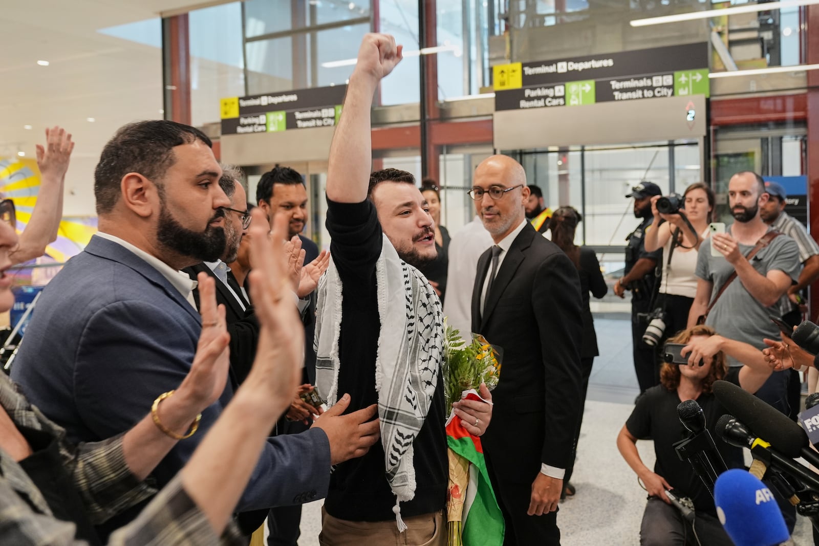 Mahmoud Khalil, center, reacts as he is greeted upon arriving at Newark International Airport, Saturday, June 21, 2025, in Newark, N.J. (AP Photo/Seth Wenig)