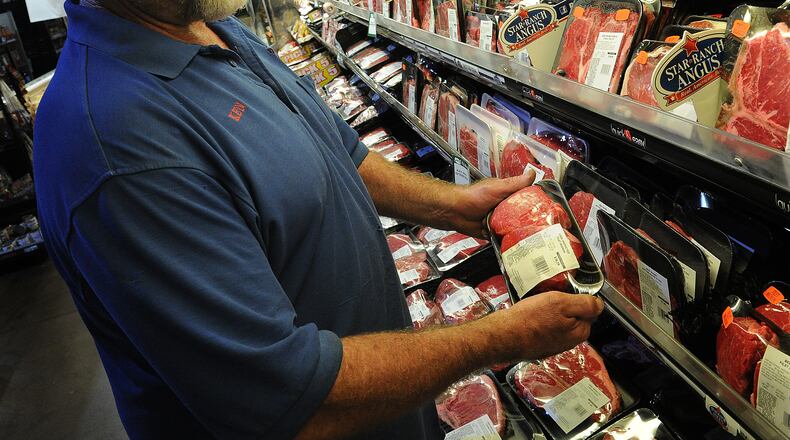 Ken Smith, selects steaks Thursday, June 30, 2022 for the upcoming holiday at the Grocerylan in Xenia. Lewis said, that the steaks from the store melt in your mouth. MARSHALL GORBY\STAFF