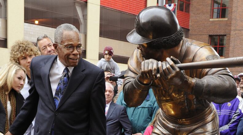 Former Minnesota Twins star Rod Carew admires the sculpture of himself at in the plaza at Target Field in Minneapolis in 2010. (AP Photo/Jim Mone)