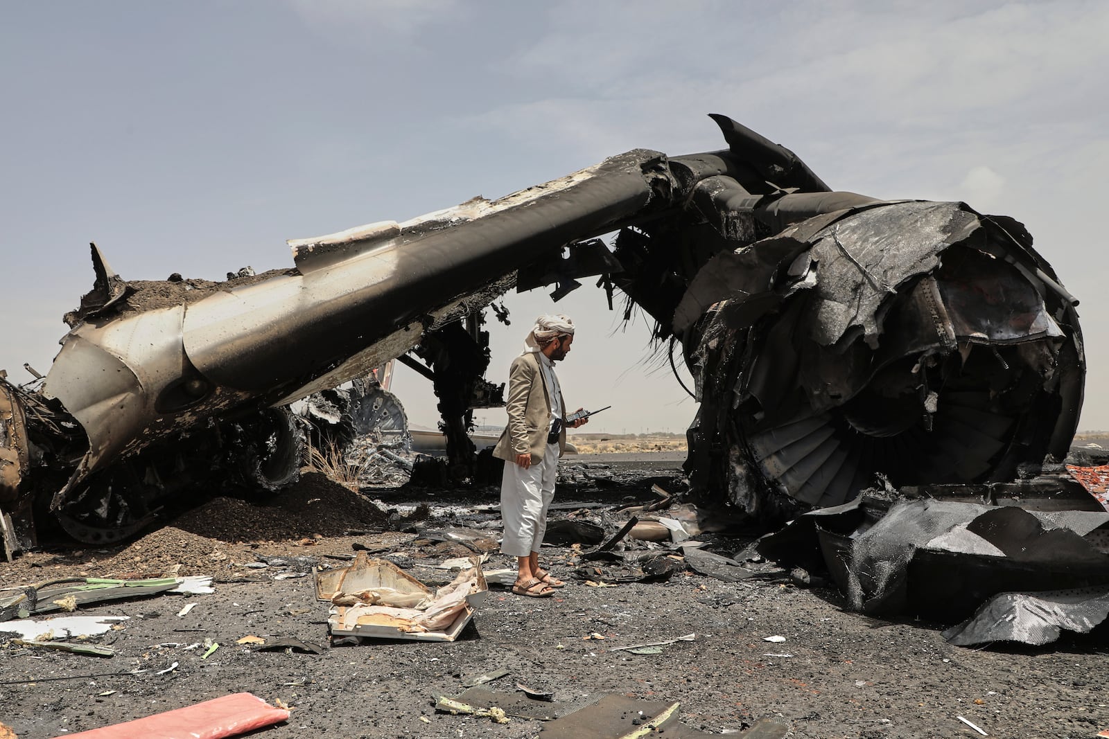 A Yemeni officer inspects the wreckage of a destroyed civilian aircraft following Israeli airstrikes on Sanaa International Airport in Sanaa, Yemen, Wednesday, May 7, 2025. (AP Photo/Osamah Abdulrahman)