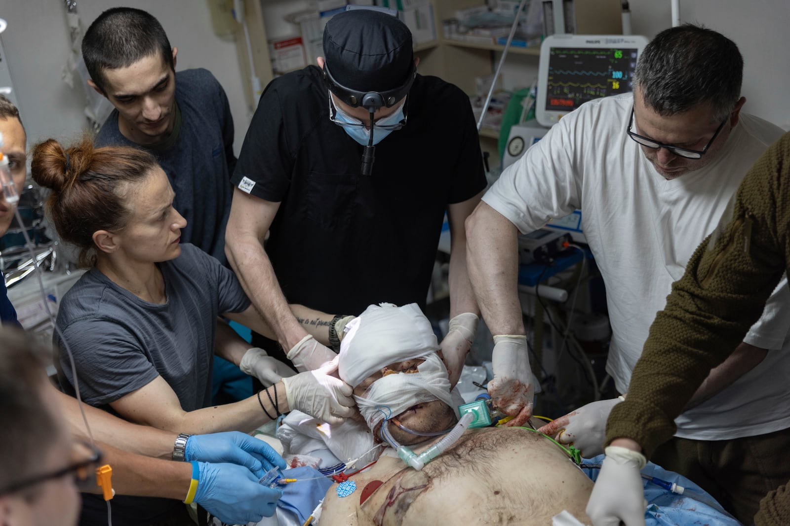 Ukrainian military medics give first aid to a wounded soldier from the 3rd Assault brigade at the field hospital in Kharkiv region, Ukraine, Sunday, May 25, 2025. (AP Photo/Yevhen Titov)