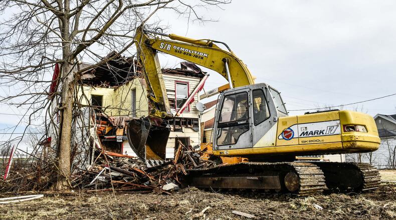 S/R Demolition of Fairfield recently tore down the house at 1007 Maple Ave., in Hamilton, one of about 420 that have been demolished in the city since early 2013. NICK GRAHAM / STAFF