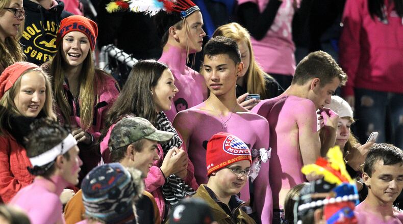 Local football fans wear pink during a 2013 game. STAFF FILE PHOTO