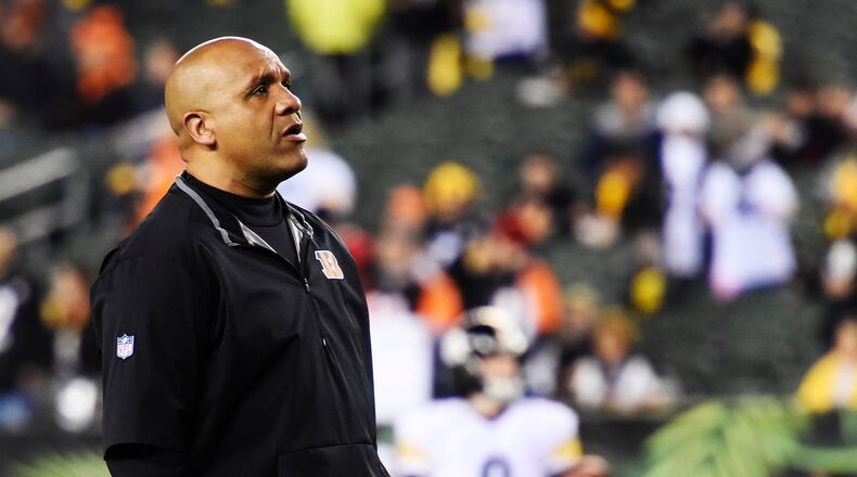 Cincinnati Bengals offensive coordinator Hue Jackson stands on the field prior to their 18-16 loss to the Pittsburgh Steelers in the AFC wild card playoff game Saturday, Jan. 9, 2016, at Paul Brown Stadium in Cincinnati. NICK GRAHAM/STAFF