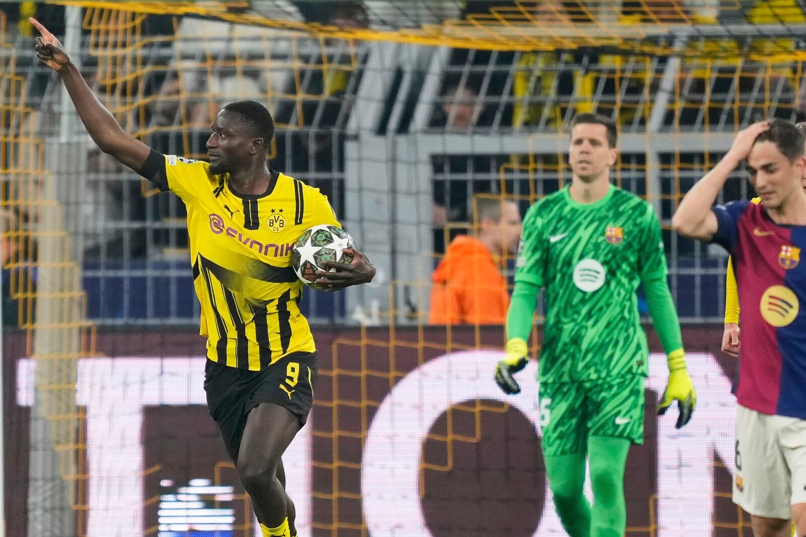 Dortmund's Serhou Guirassy, left, celebrates after scoring the opening goal during the Champions League quarterfinals second leg soccer match between Borussia Dortmund and Barcelona, at the Signa-Iduna Park in Dortmund, Germany, Tuesday, April 15, 2025. (AP Photo/Martin Meissner)